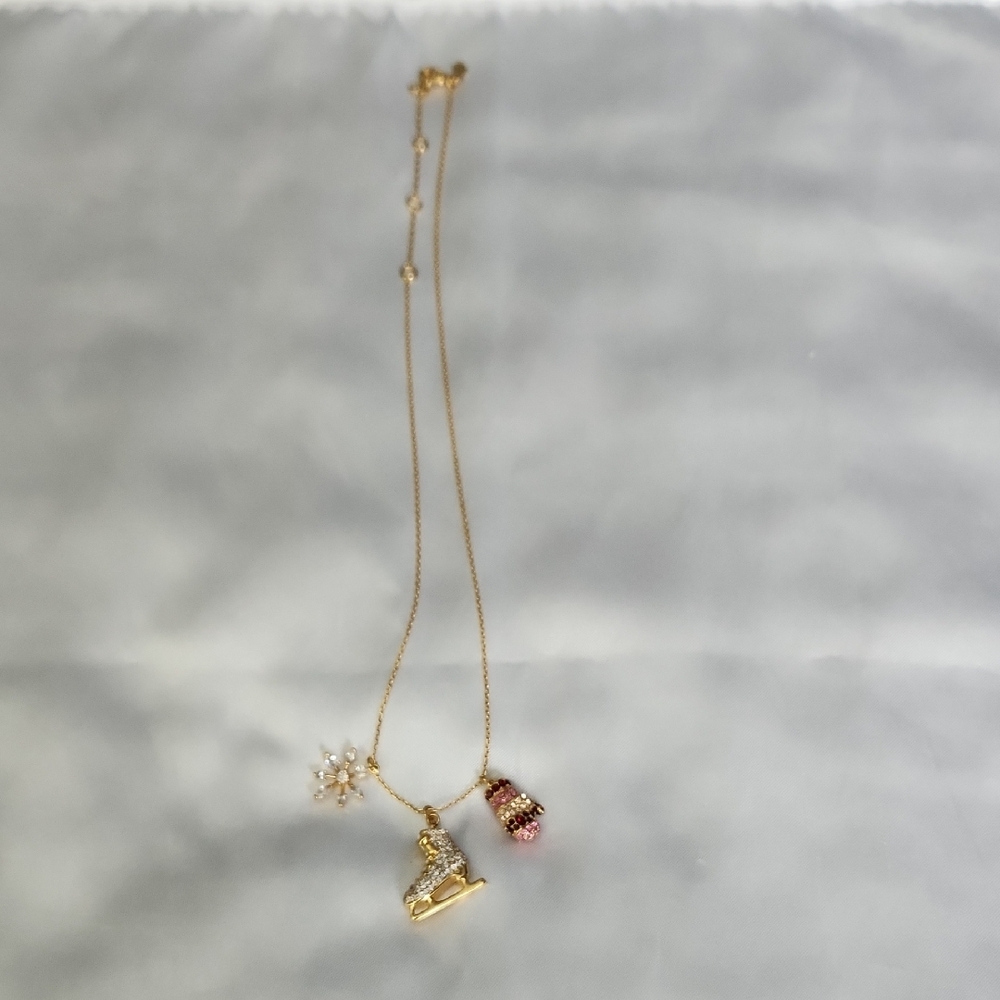 Kate Spade Gold Tone Necklace With Skate, Mitten & Crystal Snowflake Charm.